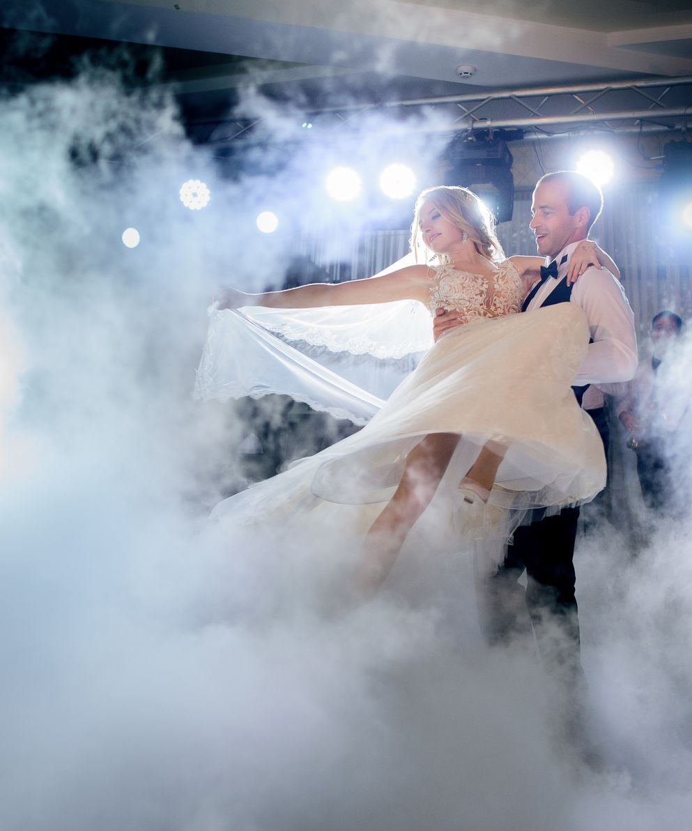 groom-whirls-bride-smoke-dancing-first-time
