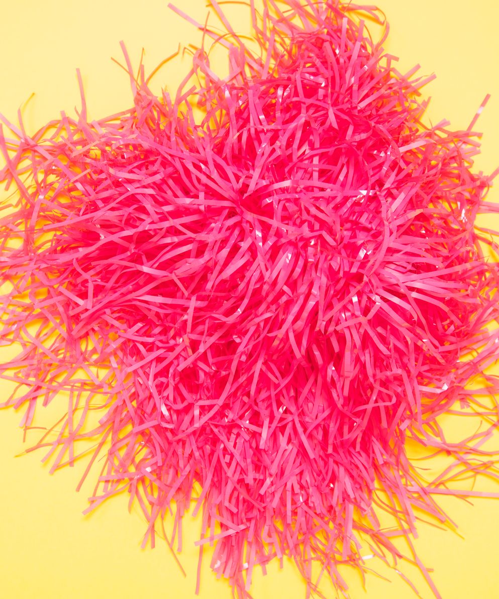 elevated-view-pink-pom-pom-yellow-background