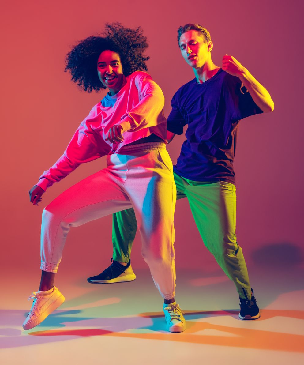 dance-time-stylish-men-woman-dancing-hip-hop-bright-clothes-green-back